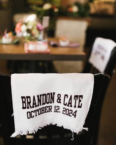 Custom white fringed wedding towel with Brandon and Cate wedding date at reception table